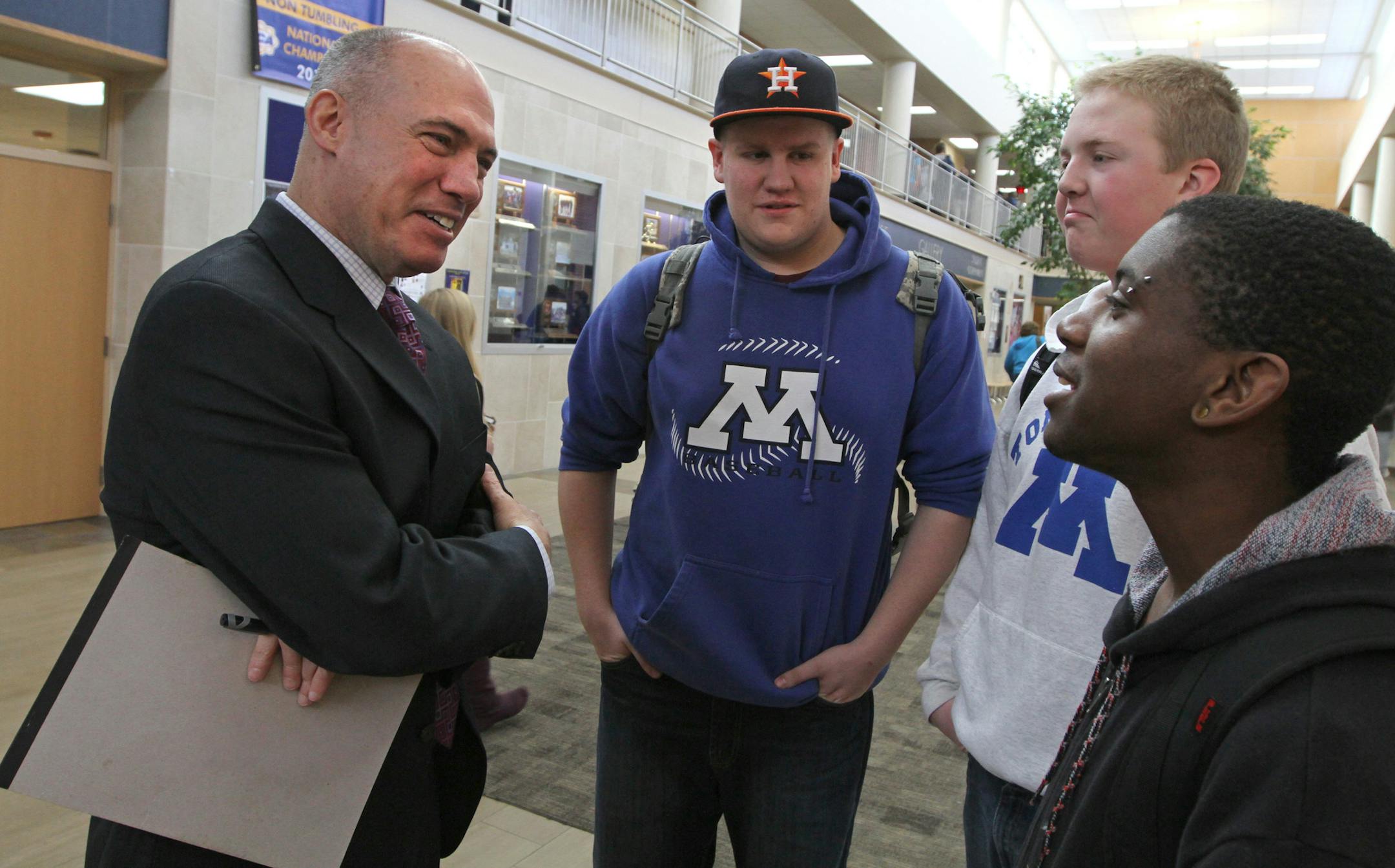 (left to right) Minnetonka High School Prinicipal Dave Adney talked with students Duncan Johnson, Derrick DeBoer and Caleb Sharp between classes in the student commons area of the school on 3/26/13.] Bruce Bisping/Star Tribune bbisping@startribune.com Dave Adney, Duncan Johnson, Derrick DeBoer, Caleb Sharp/source.