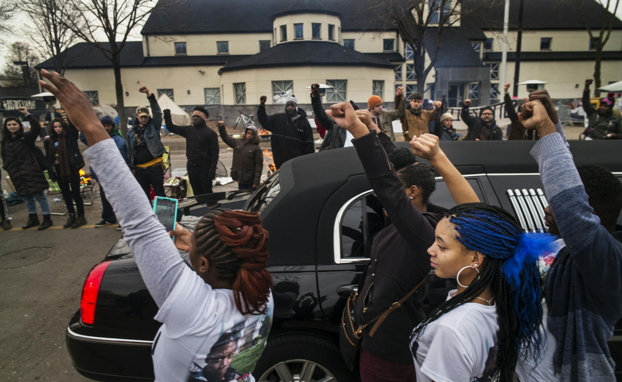 At the funeral procession for Jamar Clark at the Police 4th Precinct, family members got out of the limousine to show show support for the Black Lives Matter supporters.