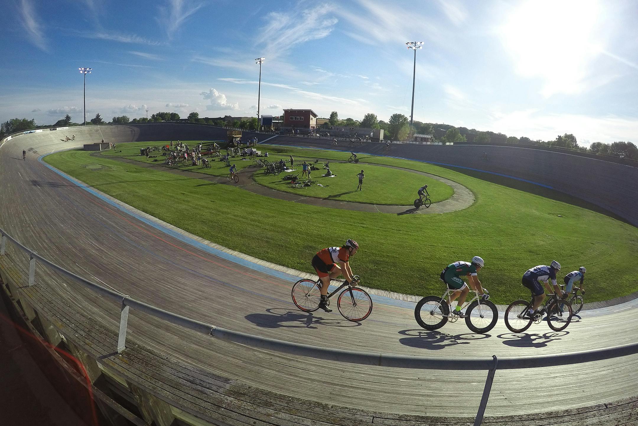 Single-speed bicycle racers make their way around the track during a Thursday Night Lights race in late June at the National Sports Center Cycling Velodrome in Blaine.