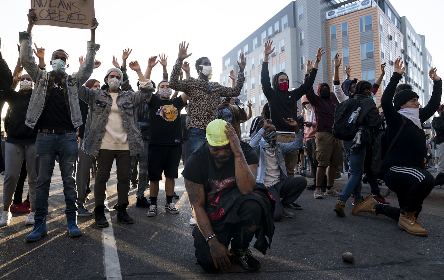 Tony Clark cried as he knelt moments before the curfew was scheduled to start near Lake Street under the Hiawatha Light Rail station in Minneapolis, Minn., on Friday, May 29, 2020. ] RENEE JONES SCHNEIDER renee.jones@startribune.com