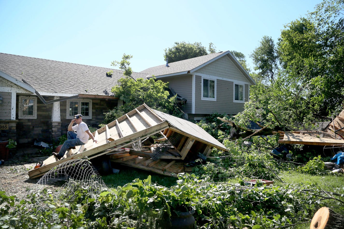 Jason Bogema sits atop a destroyed building on his property in Hollywood Township, where an EF-1 tornado with 105 mph winds touched down Saturday, July 18, 2015, near Watertown, MN.](DAVID JOLES/STARTRIBUNE)djoles@startribune.com High winds, heavy rain and a tornado whipped through the Twin Cities late Friday night and early Saturday morning, bringing down trees and knocking out power to thousands.** Jason Bogema,cq