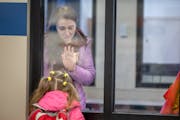Ukrainian refugee Natalia Kuchma waves goodbye to her five-year-old daughter Solomiia Kuchma at the Lake Harriet Community School's Lower Campus in Mi