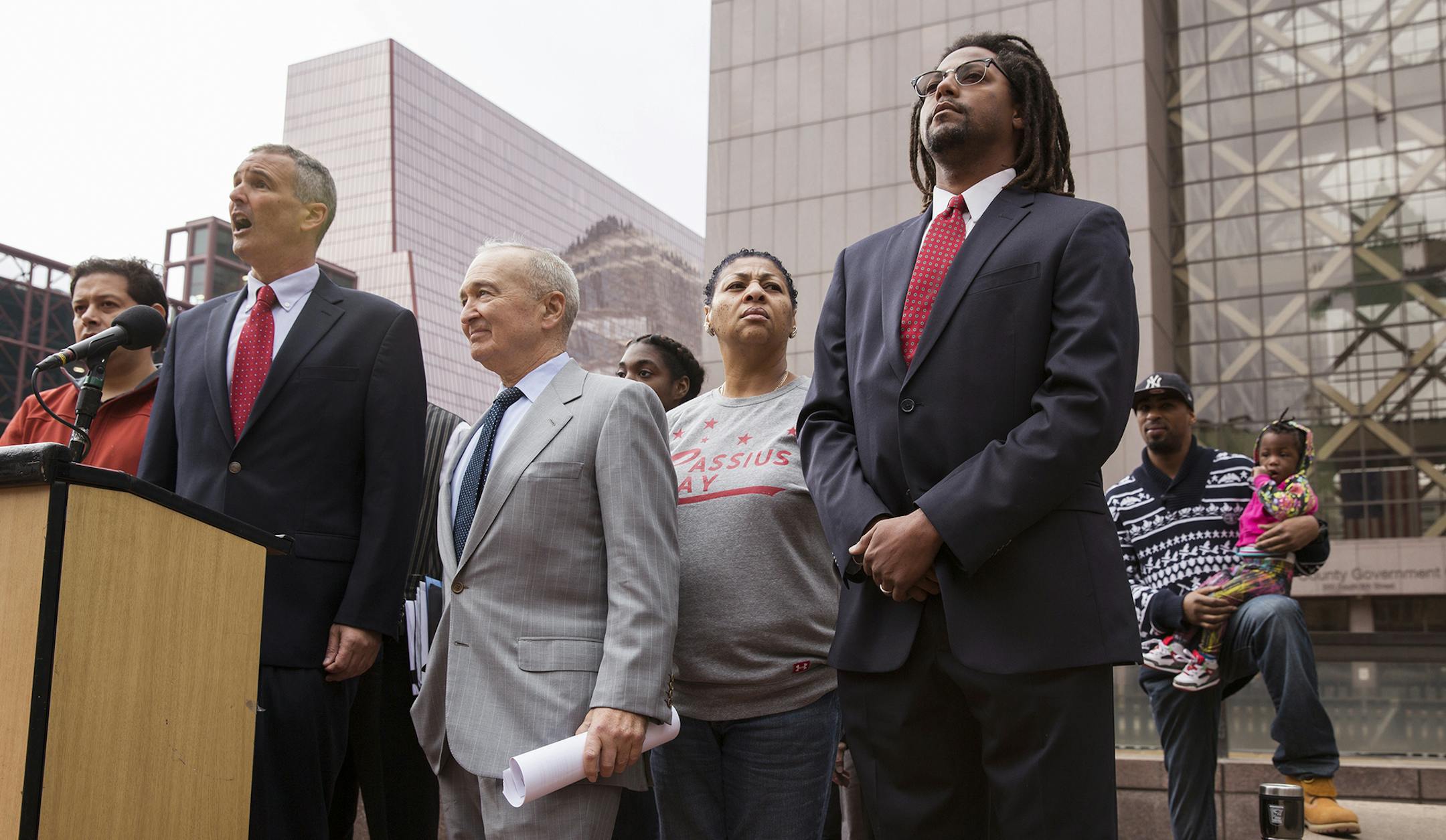 Attorneys John and Dan Shulman speak to the media, surrounded by plaintiffs in the case, during a press conference announcing a lawsuit against the state of Minnesota for allowing segregation in schools outside the Hennepin County Courthouse in downtown Minneapolis on Thursday, November 5, 2015. ] (LEILA NAVIDI/STAR TRIBUNE) leila.navidi@startribune.com BACKGROUND INFORMATION: Seven families are suing the state of Minnesota for allowing segregation of public schools and depriving families of an