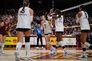 The Gophers surrounded Lydia Grote (9) after winning a point against Ohio State on Saturday night at Maturi Pavilion.