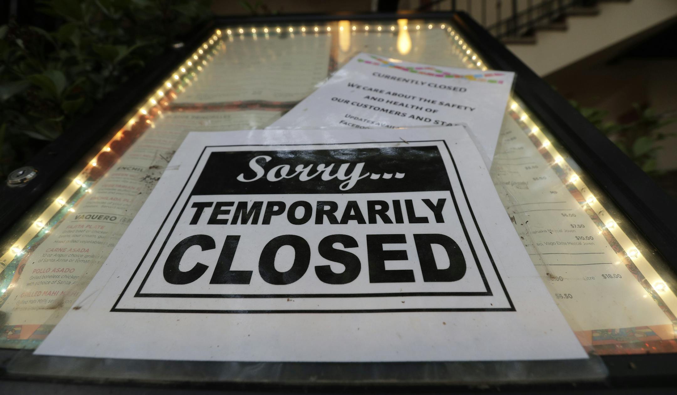 A closed sign is posted at a restaurant along the River Walk in San Antonio, Tuesday, April 28, 2020. Texas Gov. Greg Abbott is allowing Texas' stay-at-home orders to expire this week and easing restrictions on non-essential business and restaurants can open for seating with 25 percent capacity. (AP Photo/Eric Gay)