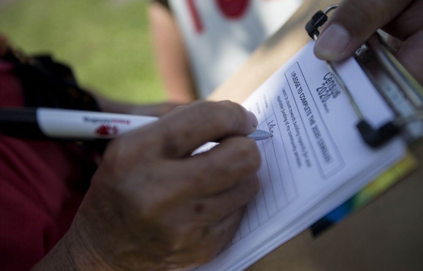 Vang Her writes her name on the census survey while also pledging to fill out the census in two years. ] ALEX KORMANN &#x2022; alex.kormann@startribune.com With the 2020 U.S. Census only two years away, local organizations have already begun to engage their communities in an effort to maximize turnout for the census. The Hmong American Census Network spent most of Saturday, walking around the Hmong Freedom Festival at Como Regional Park talking to people and conducting a mini-survey about the ce