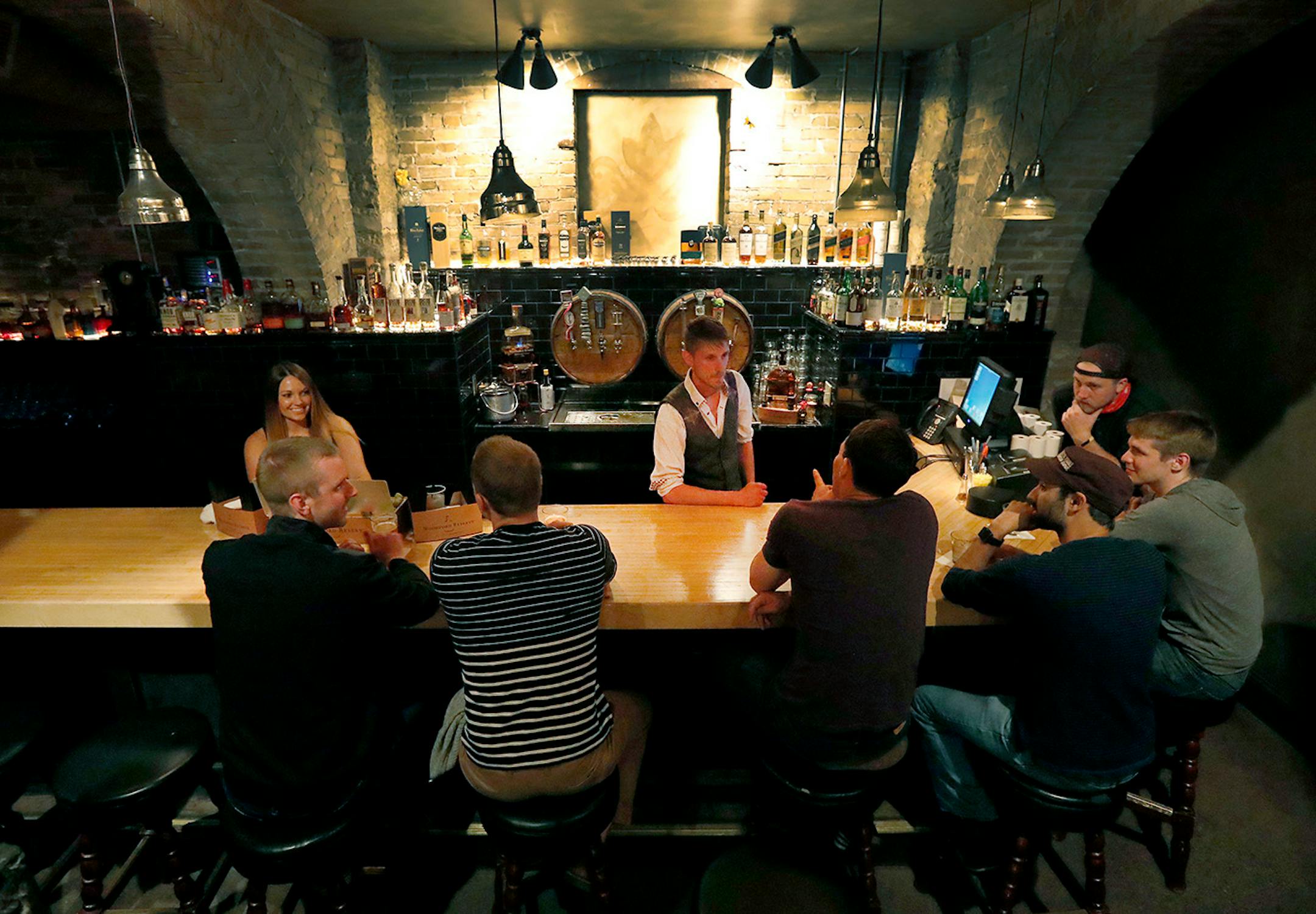 Patrons had a drink at the bar at Rathskeller, a speakeasy in Duluth.