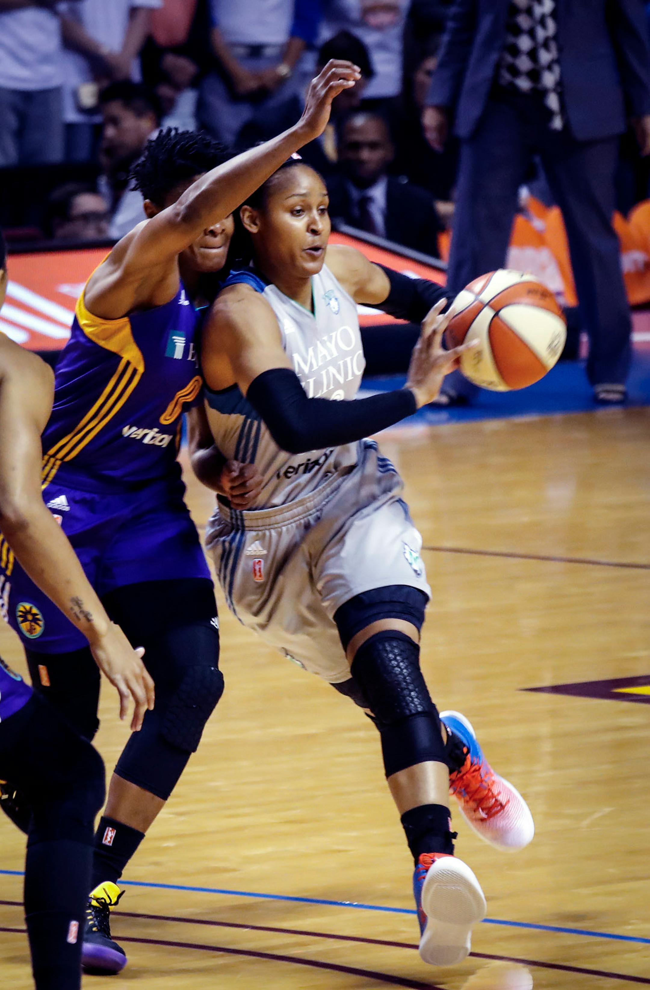 Minnesota Lynx forward Maya Moore (23) passed the ball as she was blocked by Los Angeles Sparks guard Alana Beard (0) during the first half.