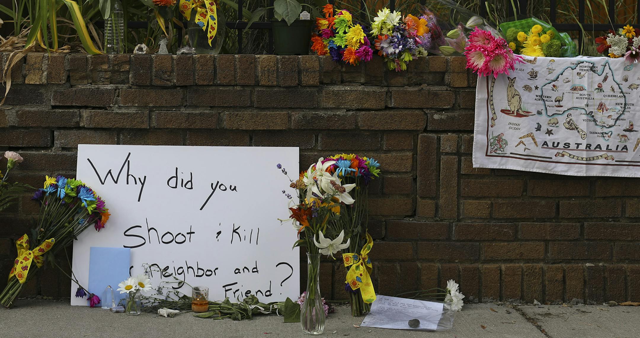 A memorial to Justine Damond on W. 51st St. near the alley where she was shot by police. ] JEFF WHEELER ï jeff.wheeler@startribune.com At least 250 people attended a vigil held Sunday evening, July 16, 2017 on W. 51st St. between Washburn and Xerxes, near where an Australian woman was shot and killed by Minneapolis Police Saturday night. ORG XMIT: MIN1707161934302412
