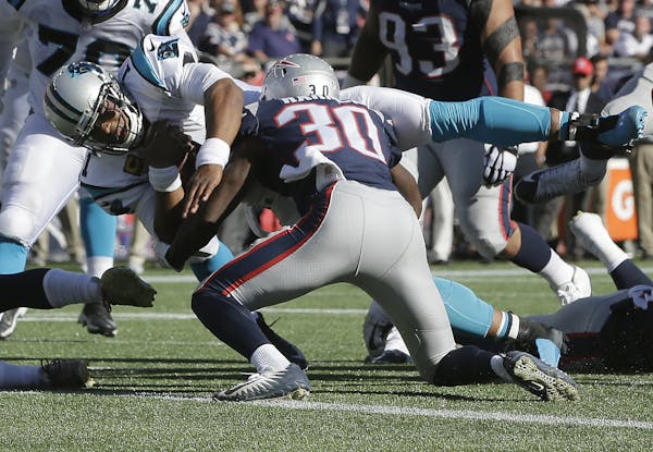 Carolina Panthers quarterback Cam Newton dives for a touchdown past New England Patriots safety Duron Harmon (30) during the second half of an NFL foo