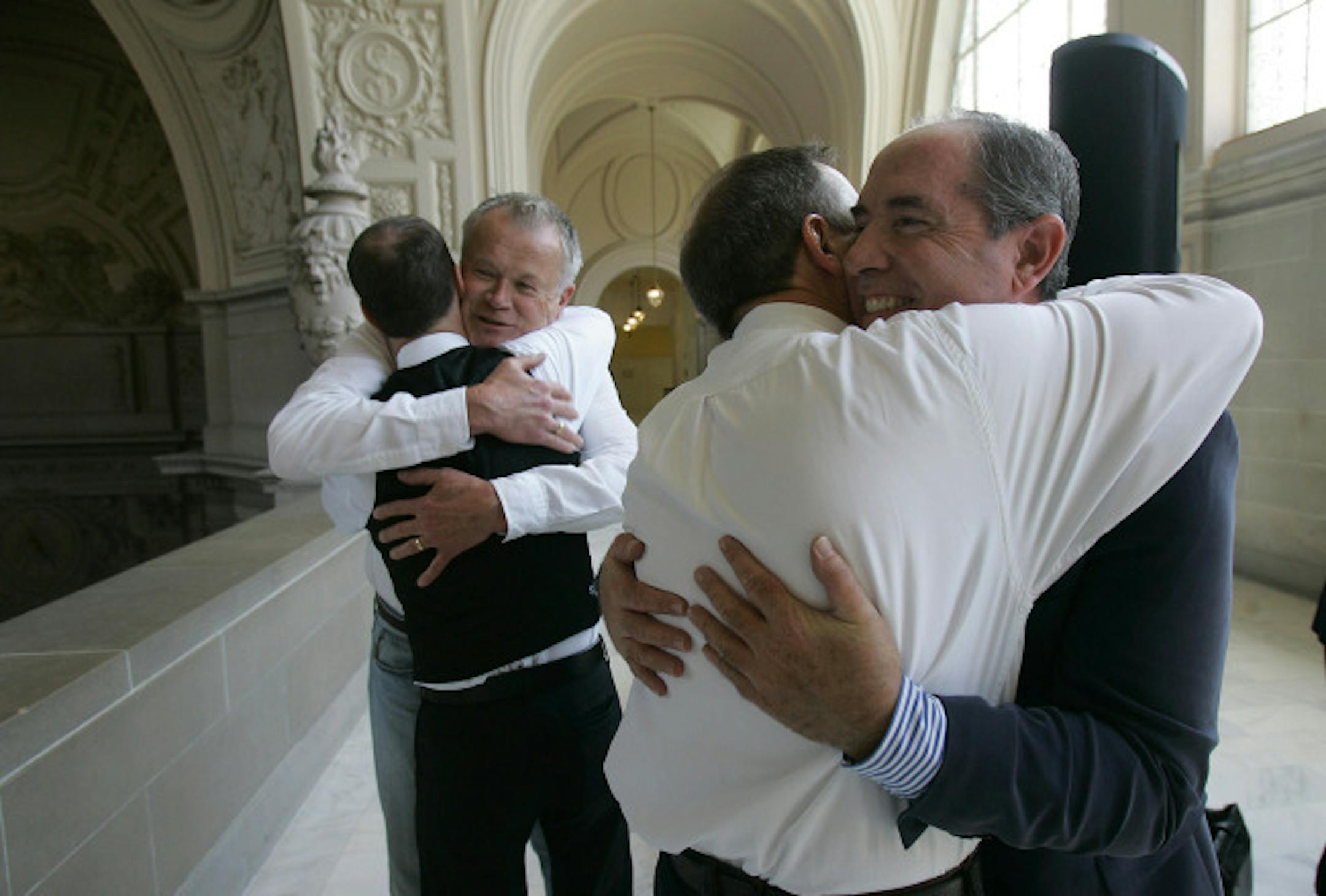 Jerry Lee, second from left, is and partner of 35 years Don Ofstedal, second from right,, from Minneapolis, Minn., are hugged by their friends Kelly Nichols, left, and John Garrett, right, after getting married at City Hall on Thursday, June 19, 2008, in San Francisco. County clerk offices opened their doors Tuesday to hundreds of gay and lesbian couples with appointments to secure marriage licenses and exchange vows on the first full day same-sex nuptials were legal throughout California.