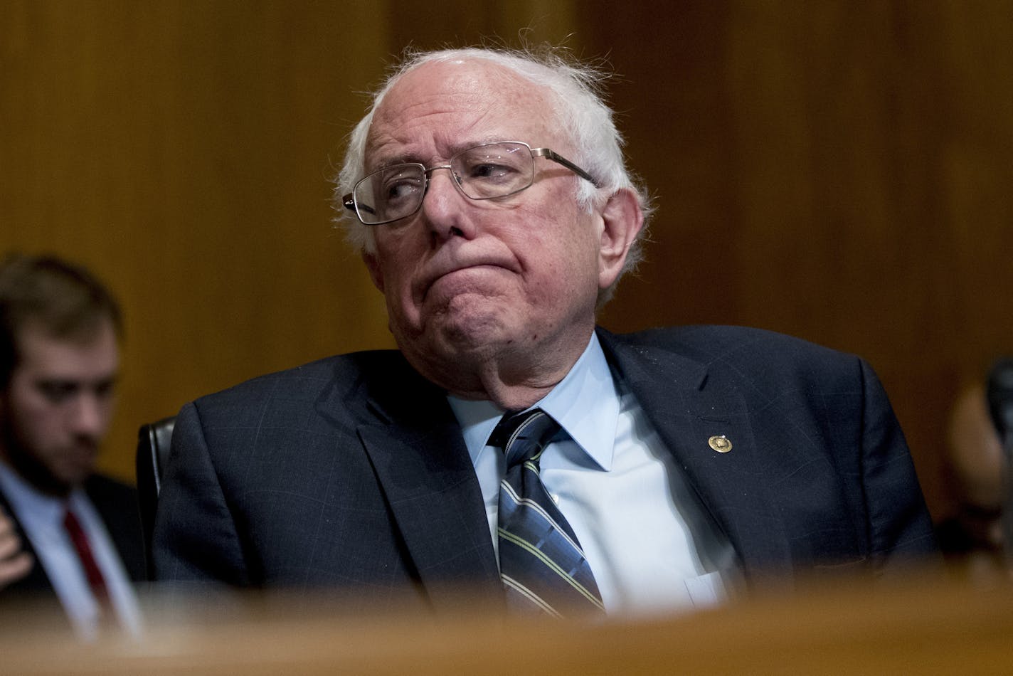 FILE - In this Jan. 16, 2019, photo, Sen. Bernie Sanders, I-Vt., reacts during a hearing on Capitol Hill in Washington. The growing Democratic presidential field is increasingly splitting into two camps: those who want to quickly overhaul economic systems that have existed for decades and those who favor more gradual change. (AP Photo/Andrew Harnik, File)