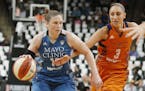 Phoenix Mercury's' Diana Taurasi, right, tries to reach the ball as Minnesota Lynx's Lindsay Whalen drives in the first quarter of a WNBA playoff semi