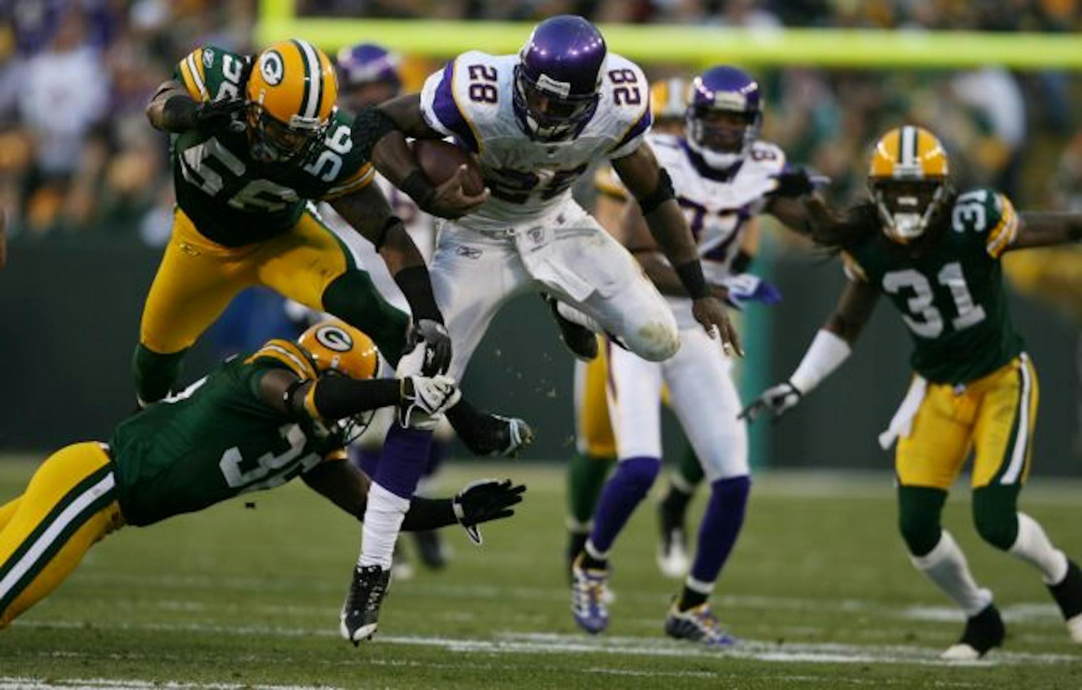 Vikings running back Adrian Peterson jumped ahead of the Packers defense for a first down in the second quarter.