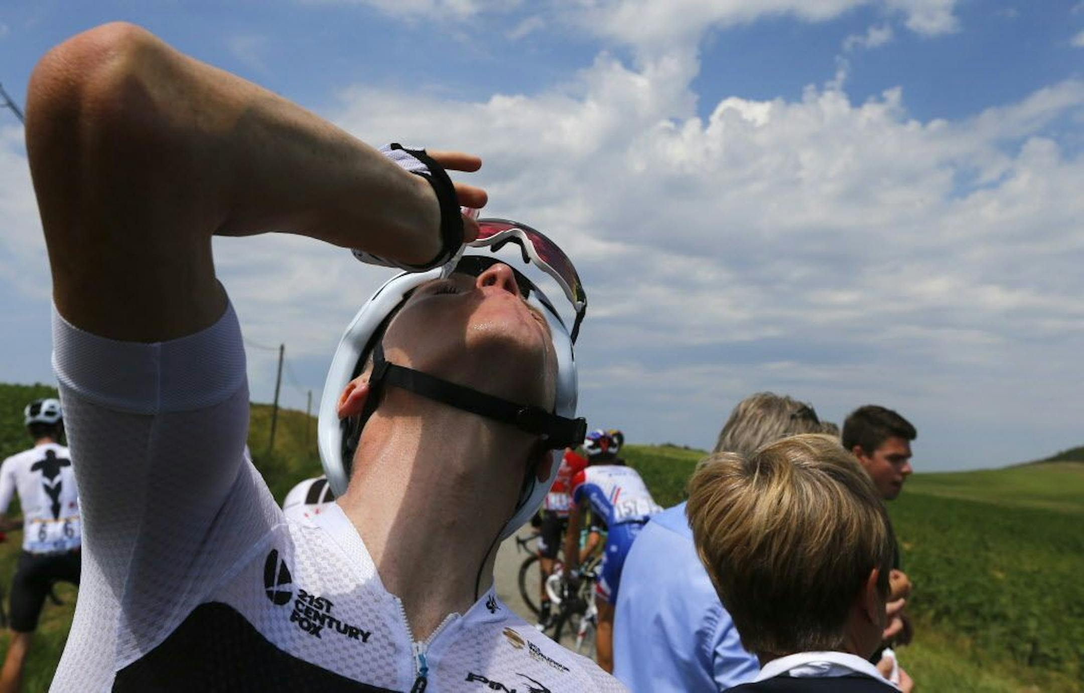 Britain's Chris Froome treats his eyes for tear gas or pepper spray sprayed on the peloton when a farmer's protest interrupted during the sixteenth stage of the Tour de France cycling race over 218 kilometers (135.5 miles) with start in Carcassonne and finish in Bagneres-de-Luchon, France, , Tuesday, July 24, 2018.