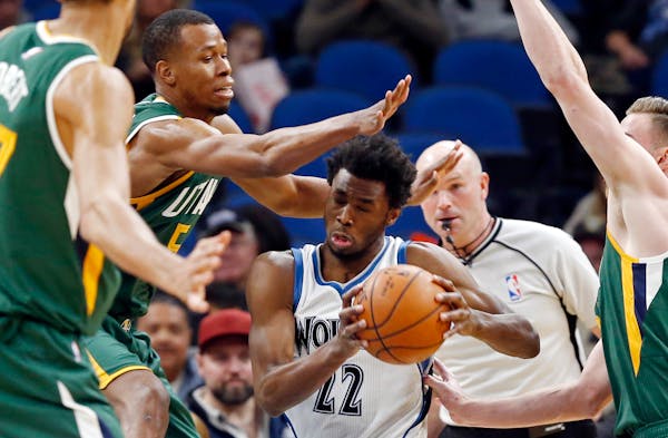 Minnesota Timberwolves' Andrew Wiggins, center, drives past Utah Jazz's Rodney Hood, second from left, during the first quarter of an NBA basketball g
