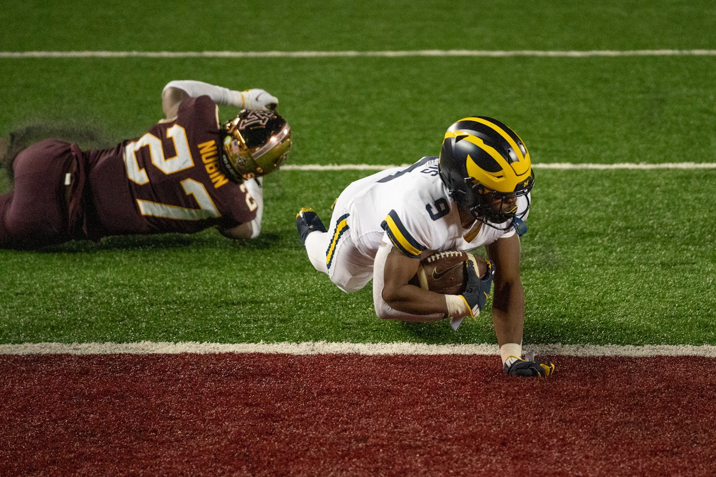 Michigan wide receiver Daniel Jackson lunged into the end zone for a fourth-quarter touchdown in the Wolverines' 49-24 victory over the Gophers in their Big Ten opener.