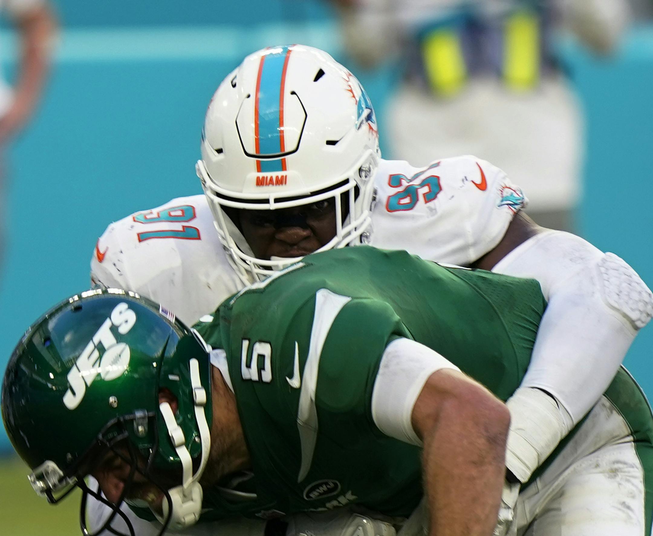 Miami Dolphins defensive end Emmanuel Ogbah (91) sacks New York Jets quarterback Joe Flacco (5), during the second half of an NFL football game, Sunday, Oct. 18, 2020, in Miami Gardens, Fla. (AP Photo/Wilfredo Lee)