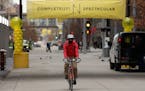 A cyclist rode down the middle of the street following a dedication ceremony to mark the opening of the newly renovated Nicollet Mall Thursday. ] ANTH
