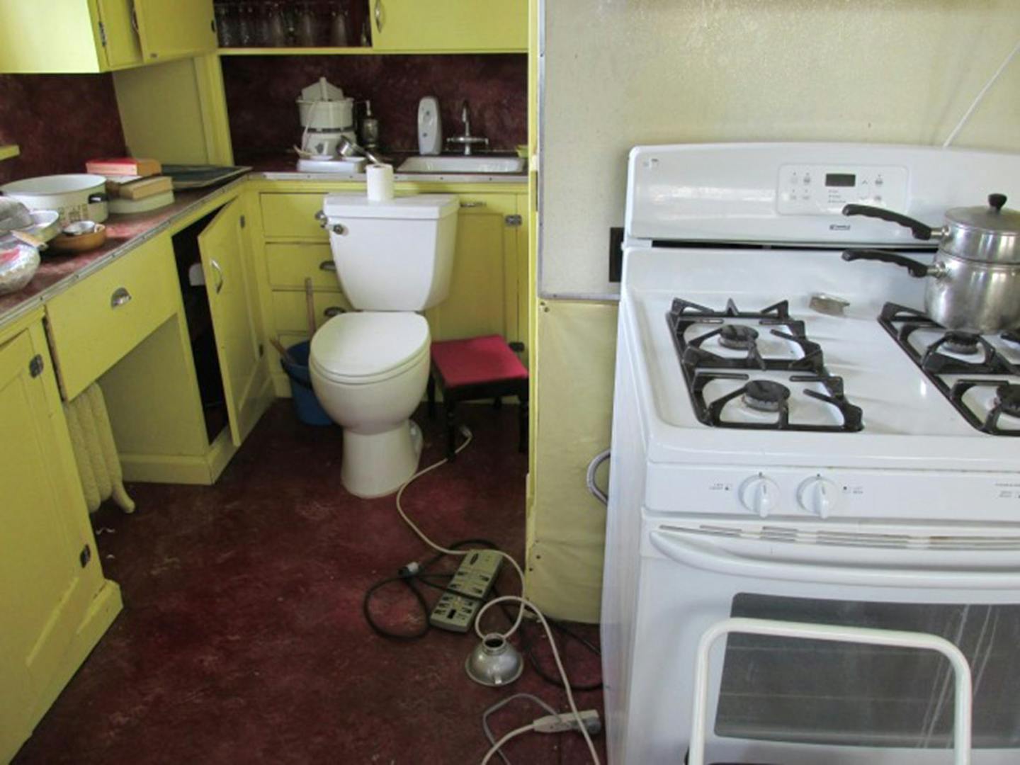 Yes, this is a toilet in a kitchen. Yes, it blocks access to the drawers and the sink base. No, we didn't "test" it.