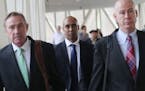 Former Minneapolis police officer Mohamed Noor, middle, is flanked by his attorneys Peter Wold, left, and Thomas Plunkett, right, as he breaks for lun