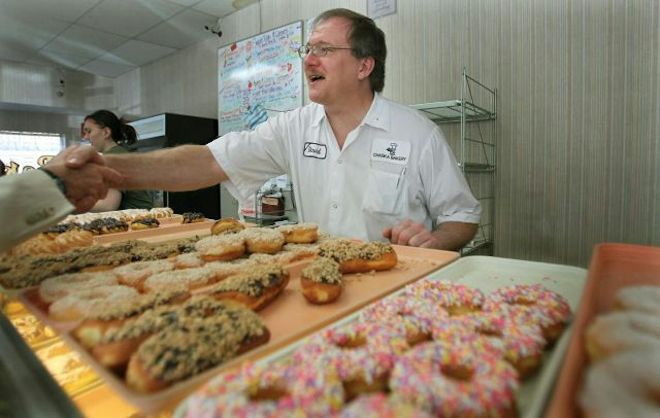 Chaska Bakery owner Dave Blackowiak, greeted customers as he worked alongside his daughter Katrina Blackowiak, 19, during their last few days of business.