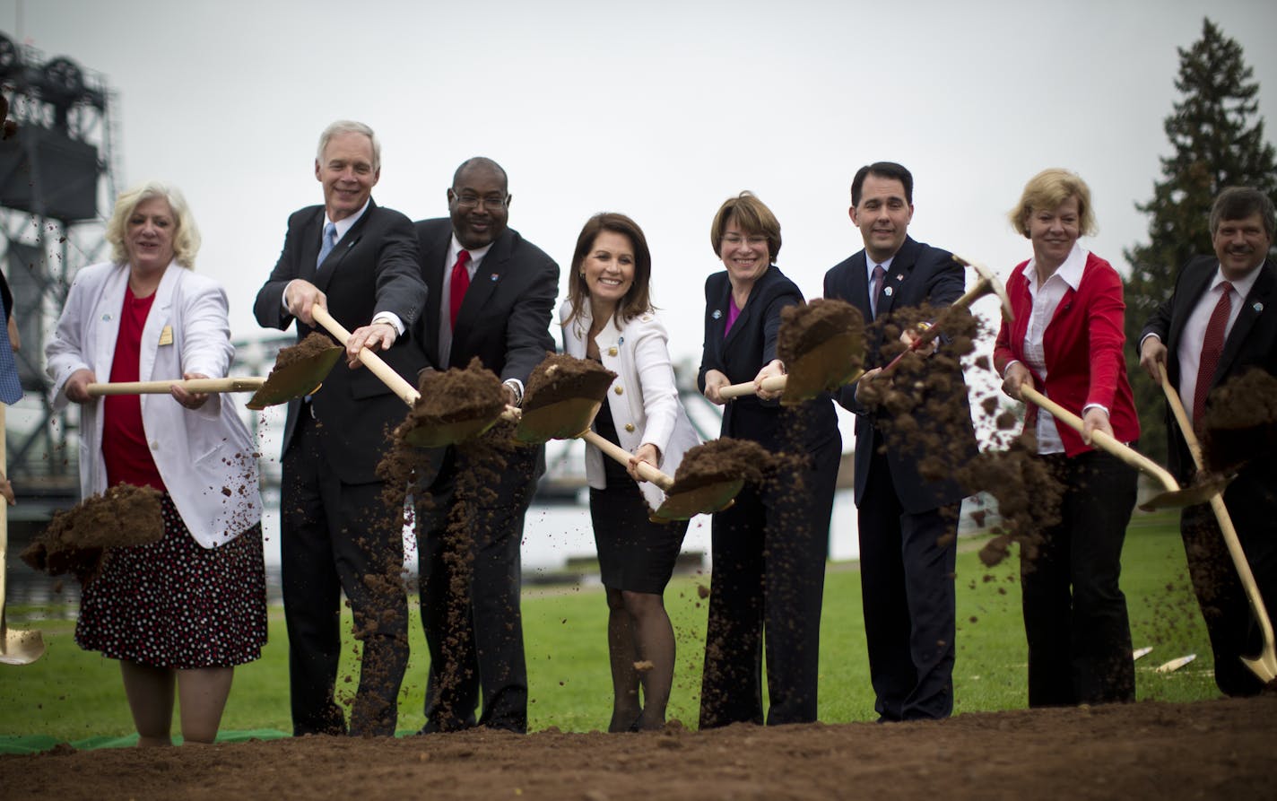 Minnesota and Wisconsin politicians participated in a ground-breaking ceremony for the new St. Croix River Bridge (already underway) on Tuesday, May 28, 2013 in Stillwater, Minn. from left Rep. Sean Duffy , Oak Park Heights Mayor Mary McComber, Sen. Ron Johnson, Derrell Turner, Federal Hwy Admin, - Rep. Michele Bachmann, Sen. Amy Klobuchar, Wisconsin Governor Scott Walker, Sen. Tammy Baldwin, Stillwater Mayor Ken Harycki. ] (RENEE JONES SCHNEIDER * reneejones@startribune.com)