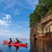 Paddlers on a sea cave tour at Apostle Islands National Lakeshore, operated by Lost Creek Adventures.
