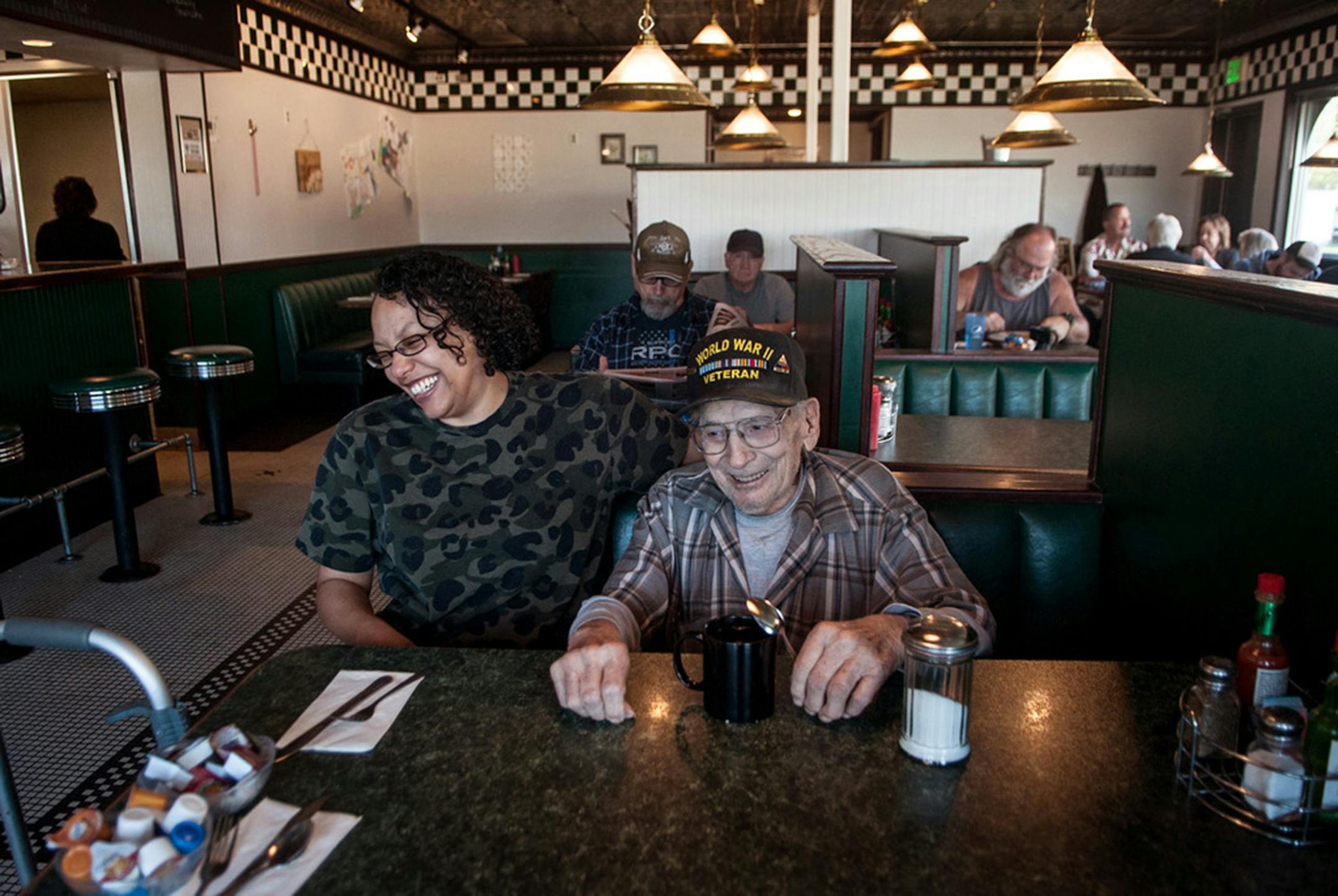 World War II veteran Dan Rankin, 95, shares a laugh with Maria Baker, manager of Dueling Irons restaurant in Post Falls, on Friday, May 10, 2019. Customers regularly pay for his breakfast. (Kathy Plonka/The Spokesman-Review/TNS) ORG XMIT: 1330299