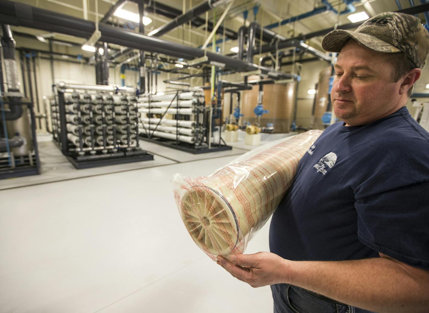 Foreman Chris Voeltz held equipment used in the reverse osmosis process at a water treatment plant in St. Peter, Minn.