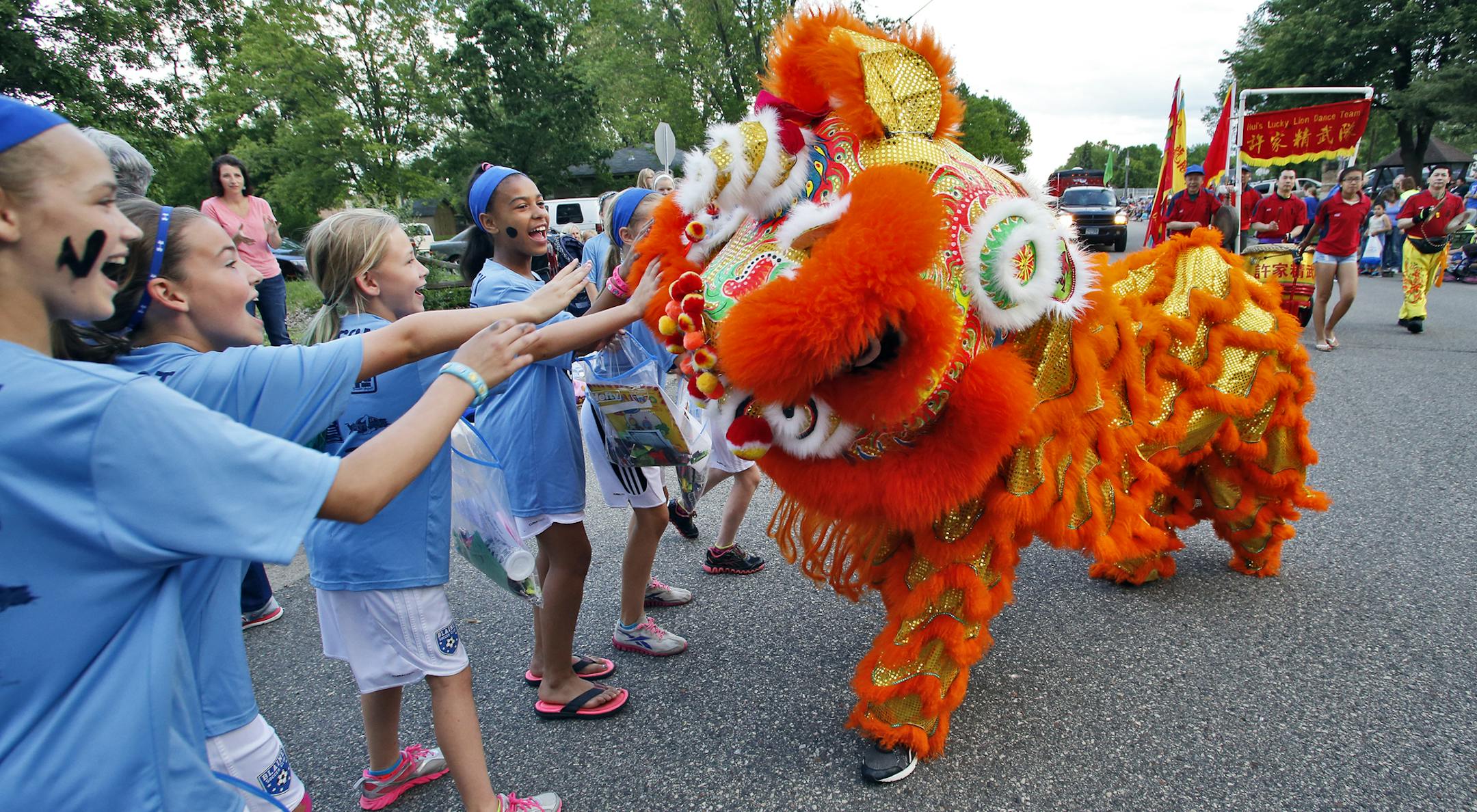 Delighting the crowd is a dancing lion from Hui's Lucky Lion Dance Team. ] Tower Days parade in Spring Lake Park. (MARLIN LEVISON/STARTRIBUNE(mlevison@startribune.com)