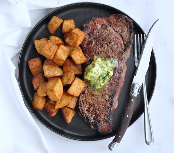 Enjoy a homemade version of Steak Frites with this steak, potatoes, and herb-filled butter.