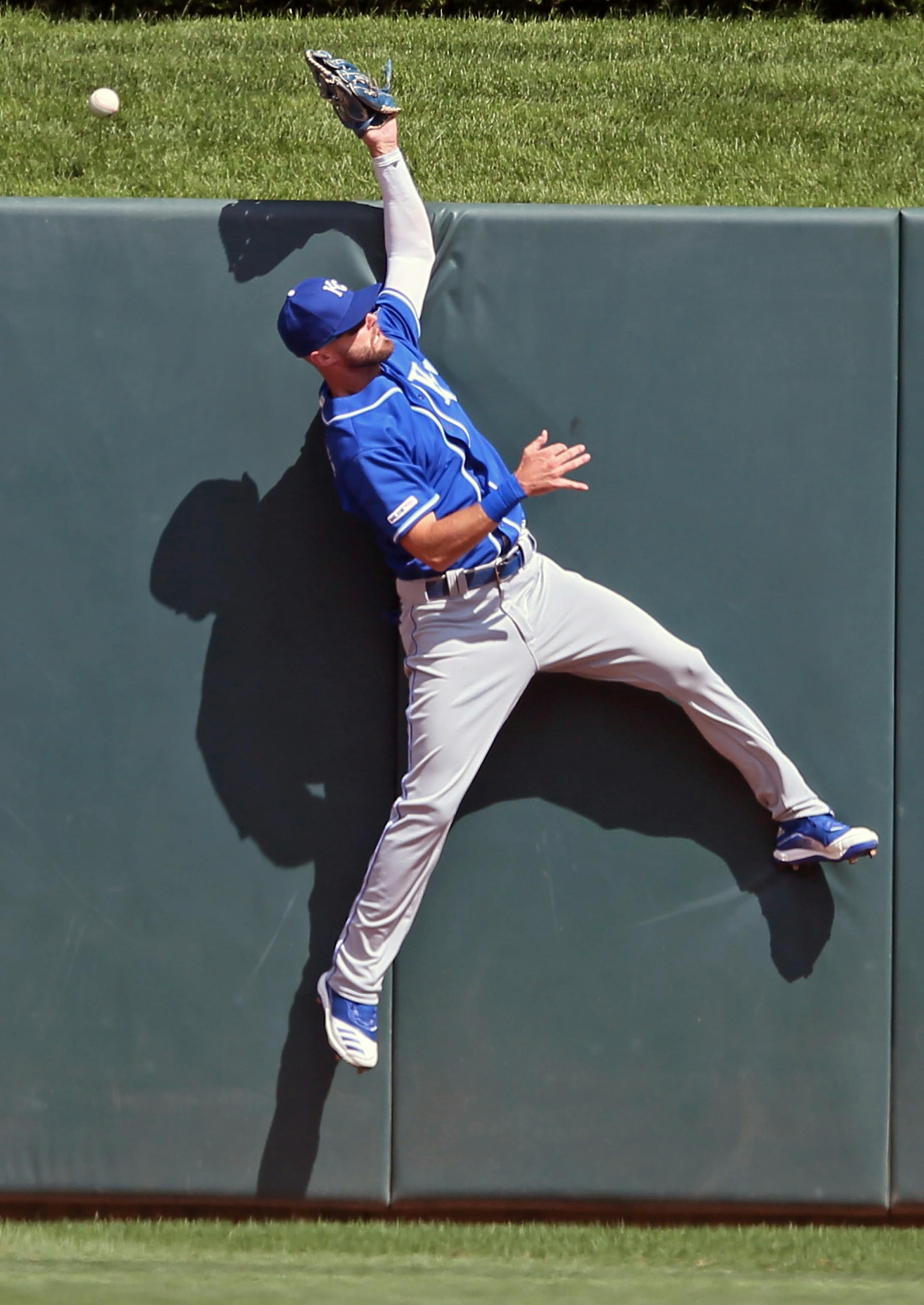 Kansas City Royals center fielder Bubba Starling goes up the wall to no avail on a home run by Minnesota Twins' Jason Castro in the seventh inning of a baseball game Sunday, Aug. 4, 2019, in Minneapolis. (AP Photo/Jim Mone)