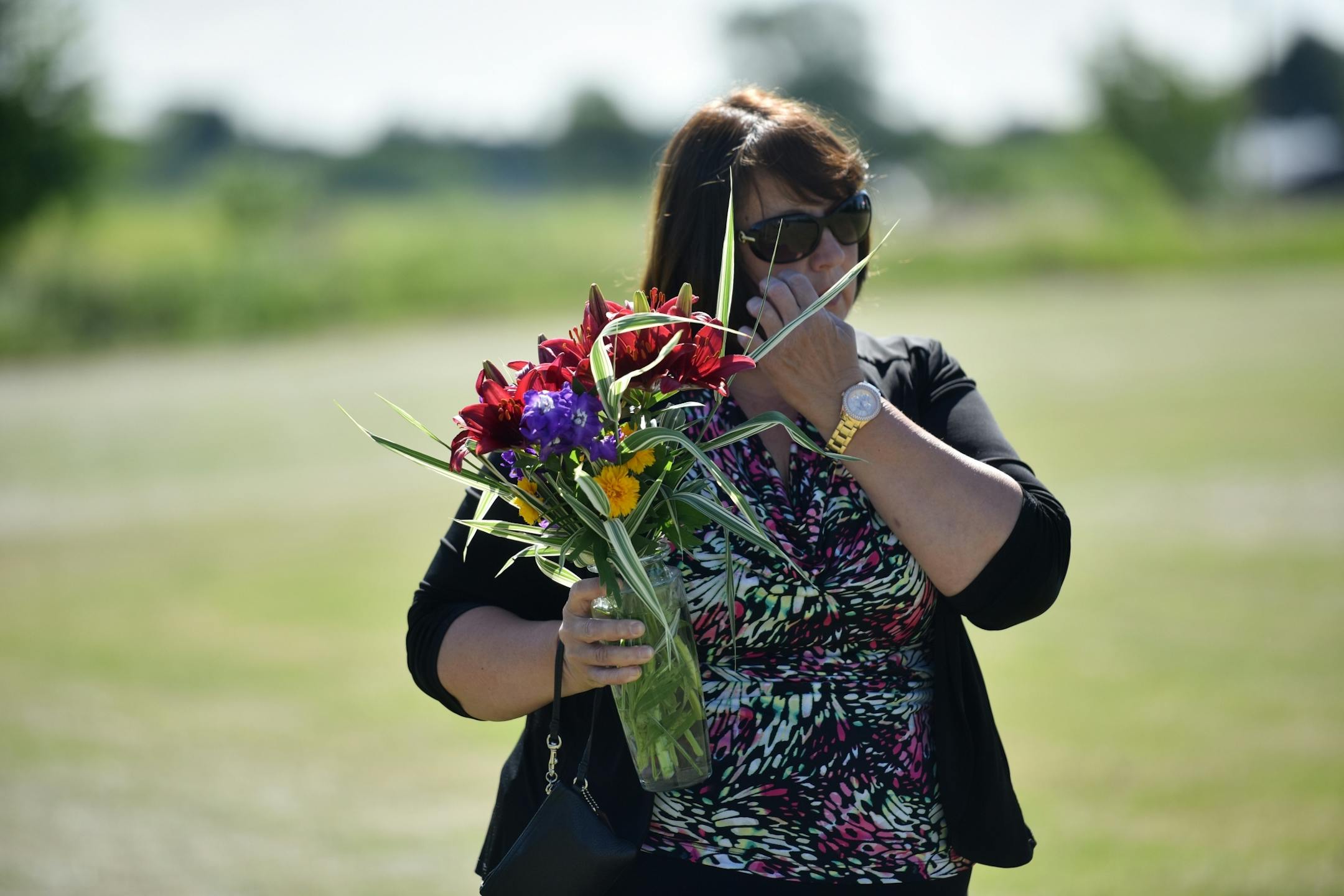 Roberta Geiselhart, who retired from the ME's office this spring, brought flowers to the gravesite.