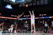 Wisconsin forward Steven Crowl (22) shoots the ball over Maryland forward Julian Reese in the first half of the Badgers' dominant victory in the secon