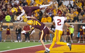 Gophers freshman Koi Perich (top) makes a game-sealing interception on Oct. 5 vs. USC at Huntington Bank Stadium.