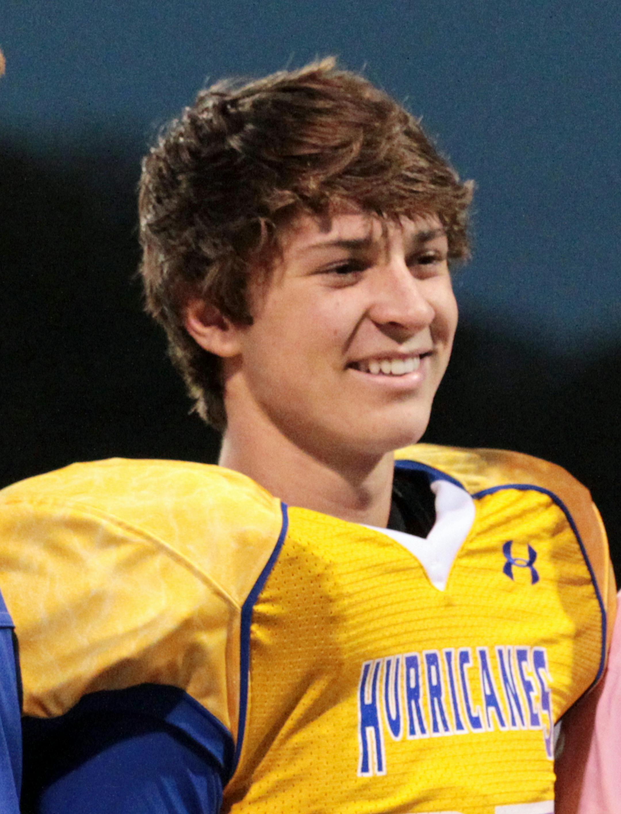 In this Oct. 19, 2012 photo, Tucker Hipps, right, stands next to Wren High School head football coach Jeff Tate while being honored during the school's senior night, in Piedmont, S.C. One day after Hipps fatally fell from a bridge after a run with his fraternity brothers, Clemson University suspended activities for all of its fraternities, citing reports of alcohol abuse and sexual misconduct but stopping short of tying the ban to the death. (AP Photo/Anderson Independent Mail, Nathan Gray) THE