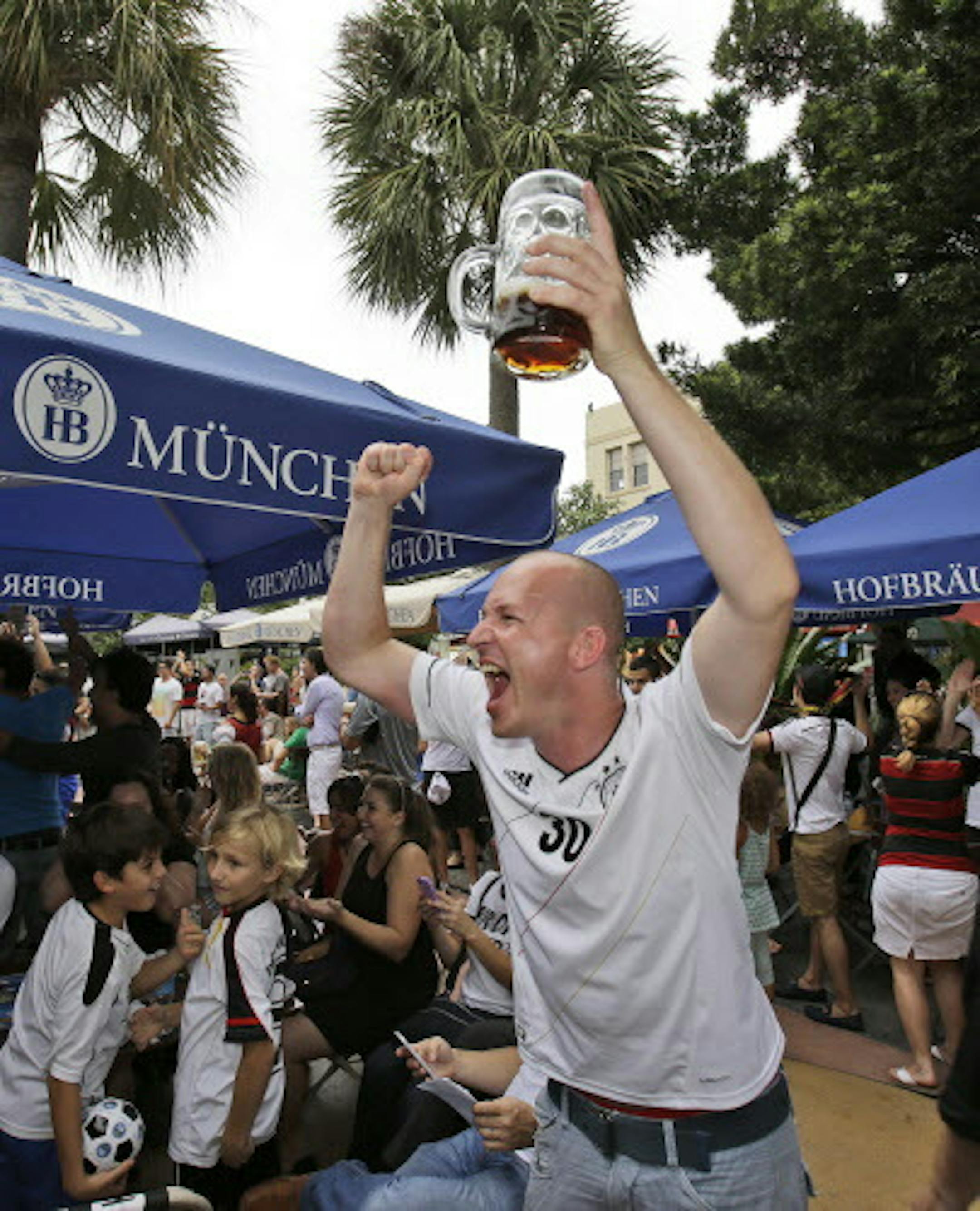 Frank Neupert of Erfurt, Germany, celebrates as he watches Germany score a goal against Brazil during the World Cup semi final, as he watches outside the Hofbrau Beer Hall, Tuesday, July 8, 2014 in Miami Beach, Fla. (AP Photo/Wilfredo Lee)