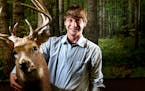 Adam Murkowski, the new DNR big game program manager, has had a passion for deer hunting and deer biology since his youth. Here he posed with a buck r