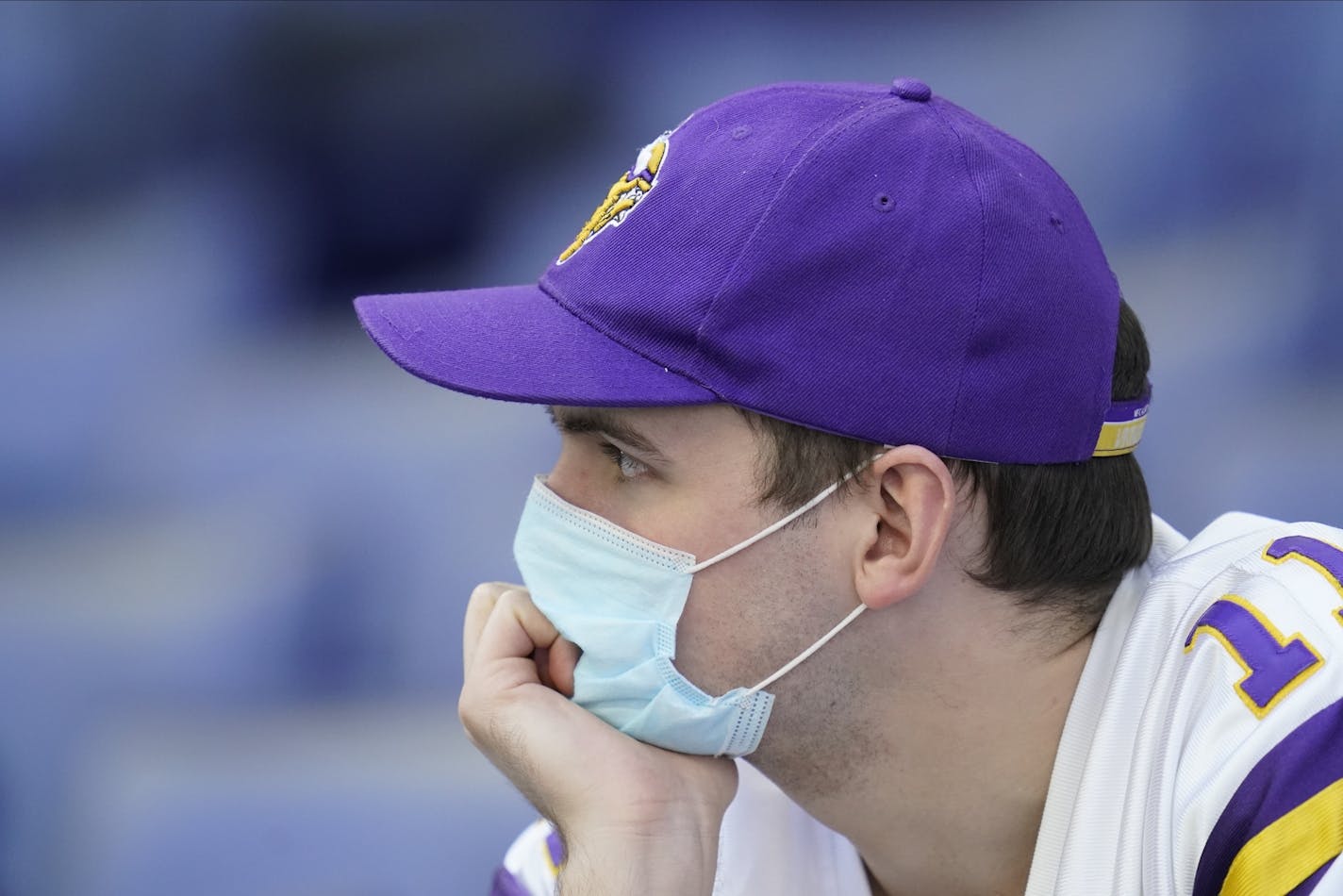 A Minnesota Vikings fan watches during the second half of an NFL football game between the Indianapolis Colts and the Minnesota Vikings, Sunday, Sept. 20, 2020, in Indianapolis. (AP Photo/Michael Conroy)