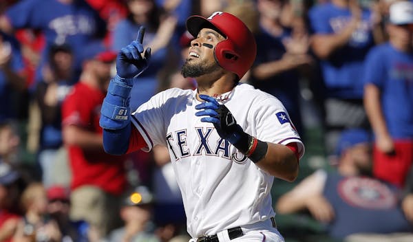 Texas Rangers' Robinson Chirinos celebrates his solo home run as he approaches the plate in the eighth inning of a baseball game against the Kansas Ci