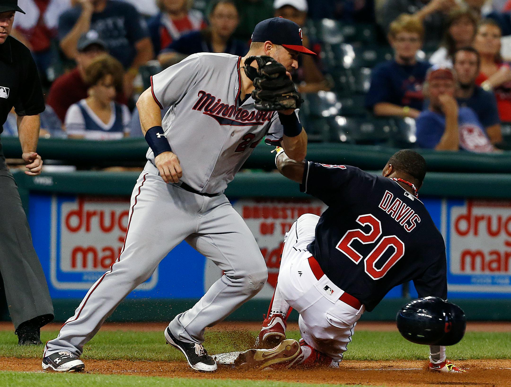 Cleveland Indians' Rajai Davis (20) steals third base as Minnesota Twins' Trevor Plouffe (24) tries to make the tag during the eighth inning of a baseball game Wednesday, Aug. 31, 2016, in Cleveland. The Indians won 8-4. (AP Photo/Ron Schwane)