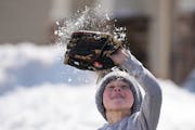 Luke Isaacson, 9, was happy to get outside for a game of catch with his dad, Mark, after 10 inches of snow fell in April.