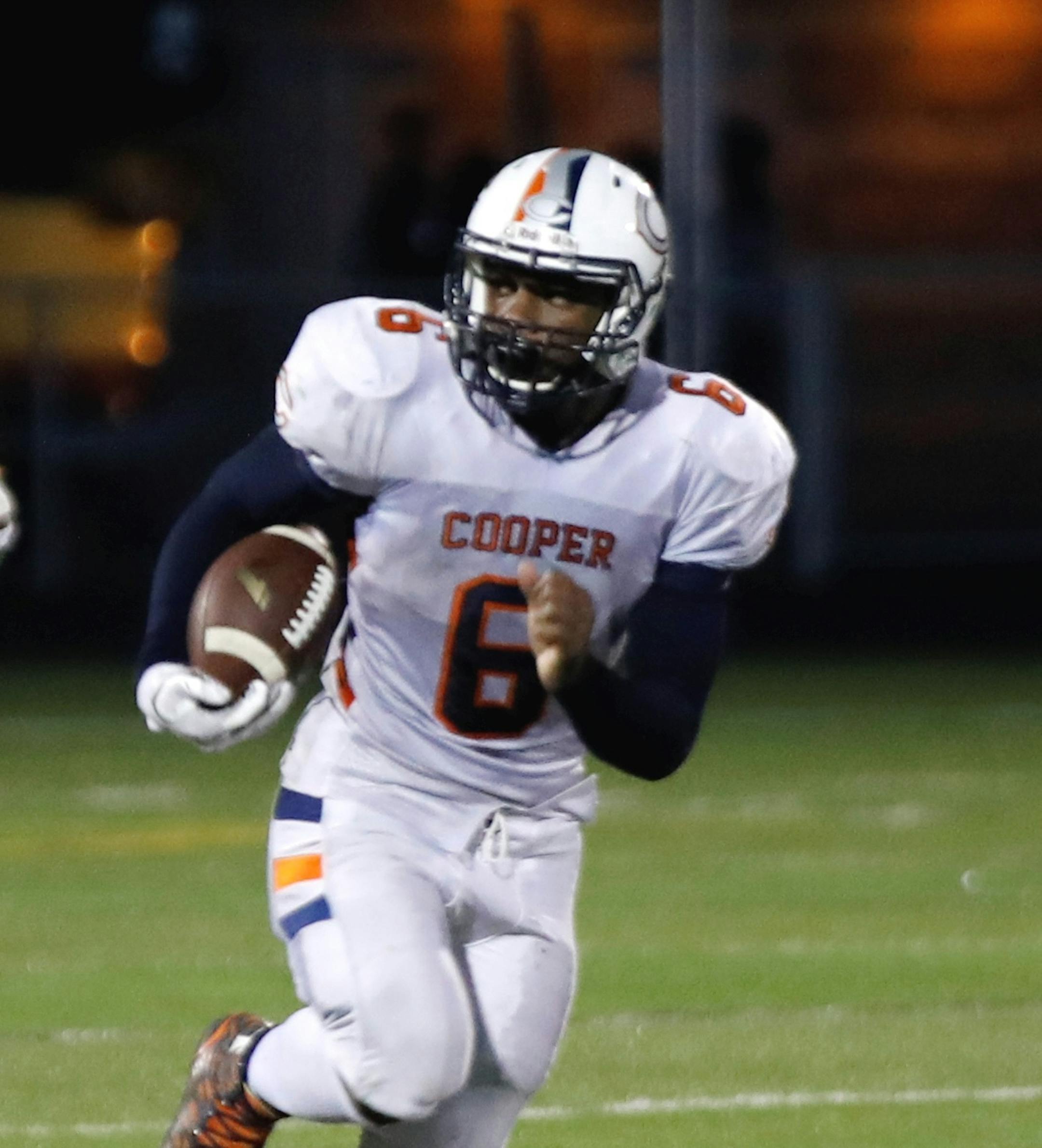 Cooper's Nate Hill runs with the ball in a 35-0 victory over Park Center.