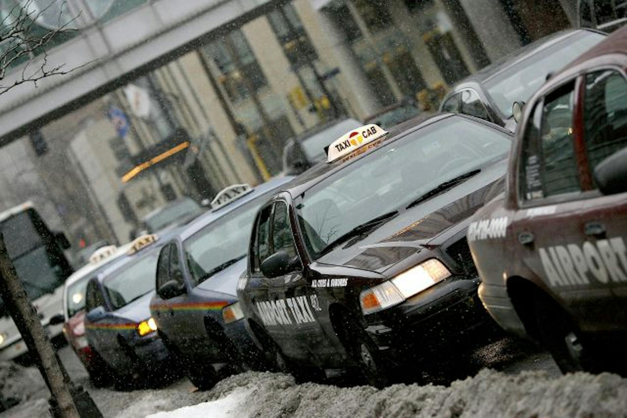 Taxis kept their motors running as they waited for cutomers outside the Hilton Hotel in downtown Minneapolis.