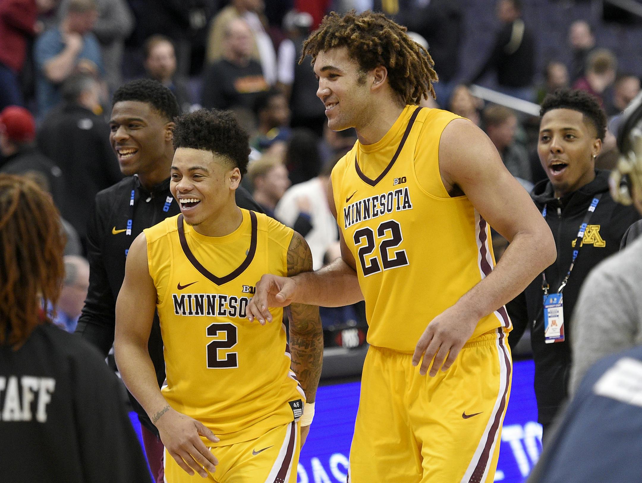 Minnesota center Reggie Lynch (22) and guard Nate Mason (2) react as they leave the court after an NCAA college basketball game against Michigan State in the Big Ten tournament, Friday, March 10, 2017, in Washington. Minnesota won 63-58. (AP Photo/Nick Wass)