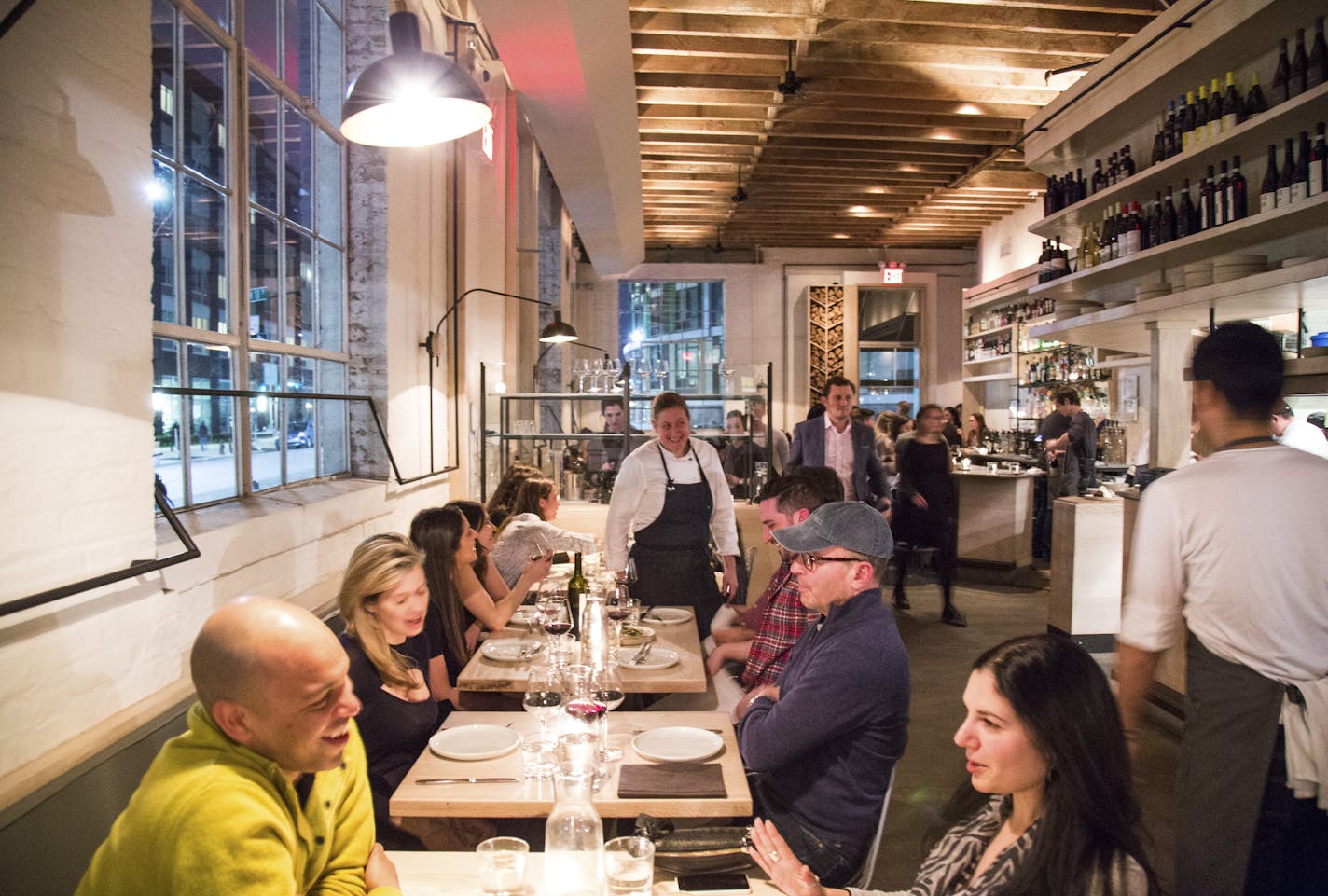 Chef and owner Missy Robbins, center, talks to diners inside Lilia in New York, March 22, 2016. Critic Pete Wells names his favorite New York restaurants in 2016: The chef and owner of this casual Italian restaurant, Missy Robbins, is a sleight-of-hand cook. You don&#x2019;t see her tricks coming, but you taste them and wonder how she did it. (Devin Yalkin/The New York Times) ORG XMIT: XNYT130