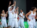 The Lynx's Lindsay Whalen and the Team USA bench cheers on Diana Taurasi after Taurasi hit a three-pointer in the third quarter of Saturday's gold med