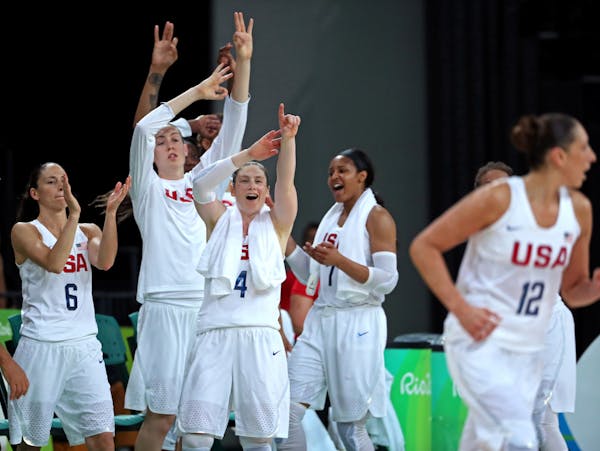The Lynx's Lindsay Whalen and the Team USA bench cheers on Diana Taurasi after Taurasi hit a three-pointer in the third quarter of Saturday's gold med