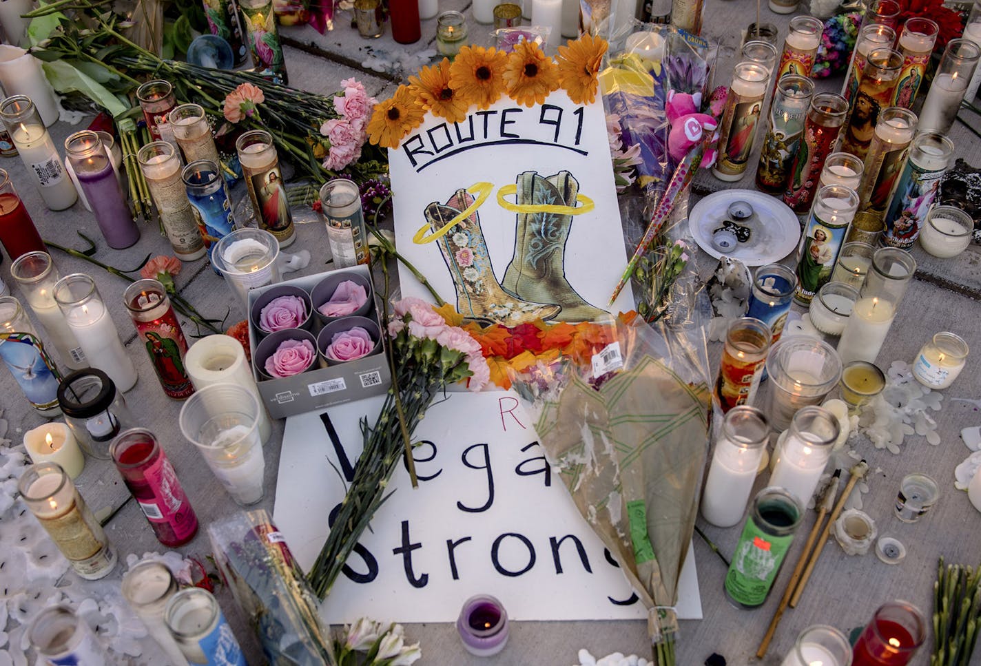 A makeshift memorial to victims of the mass shooting on Sunday night, on the northern end of the Las Vegas strip, Oct. 3, 2017. A lone gunman opened fire from the 32nd floor of the Mandalay Bay Casino and Resort on Sunday night, killing at least 59 and wounding at least 527 more at a country music festival below. (Hilary Swift/The New York Times) ORG XMIT: MIN2017100312082522